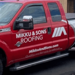 Mikku and Sons red repair track with its logo painted on its side- roofing company track wraps
