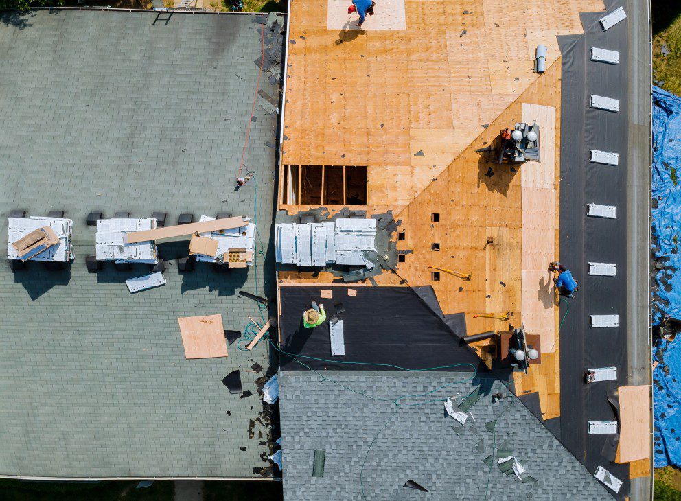 birds eye of a group of roofers installing estate grey architectural shingles on top of a roof. How to Shingle a Roof