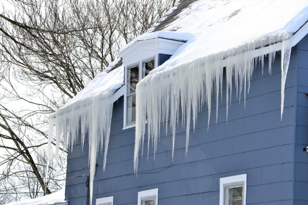 Extreme weather like snow and icicles can cause serious damage to your roof, for article How Long Does a Roof Last