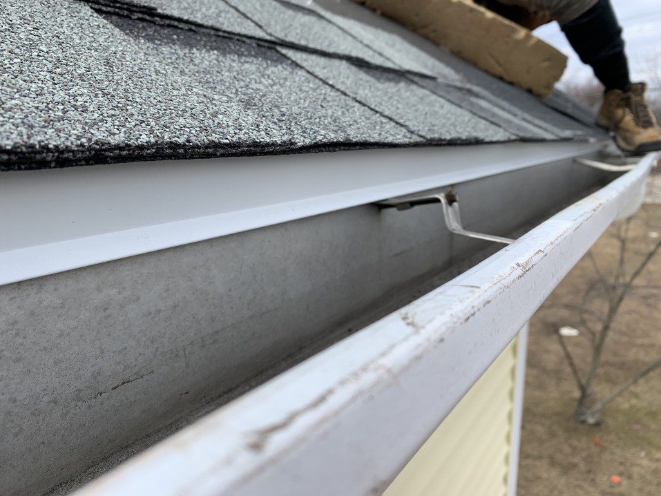 A contractor installing a drip edge after damaging weather
