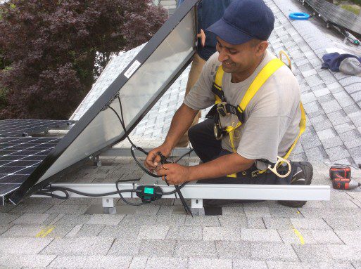A solar installer and roofer working together