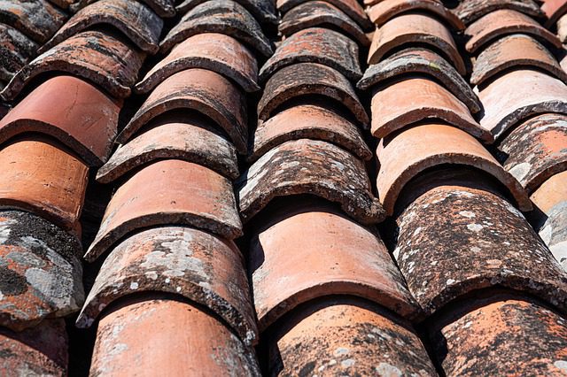 How long does a tile roof last in Arizona? An image showing a damaged tile roof
