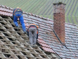 A tile roof being repaired, tile roof installation